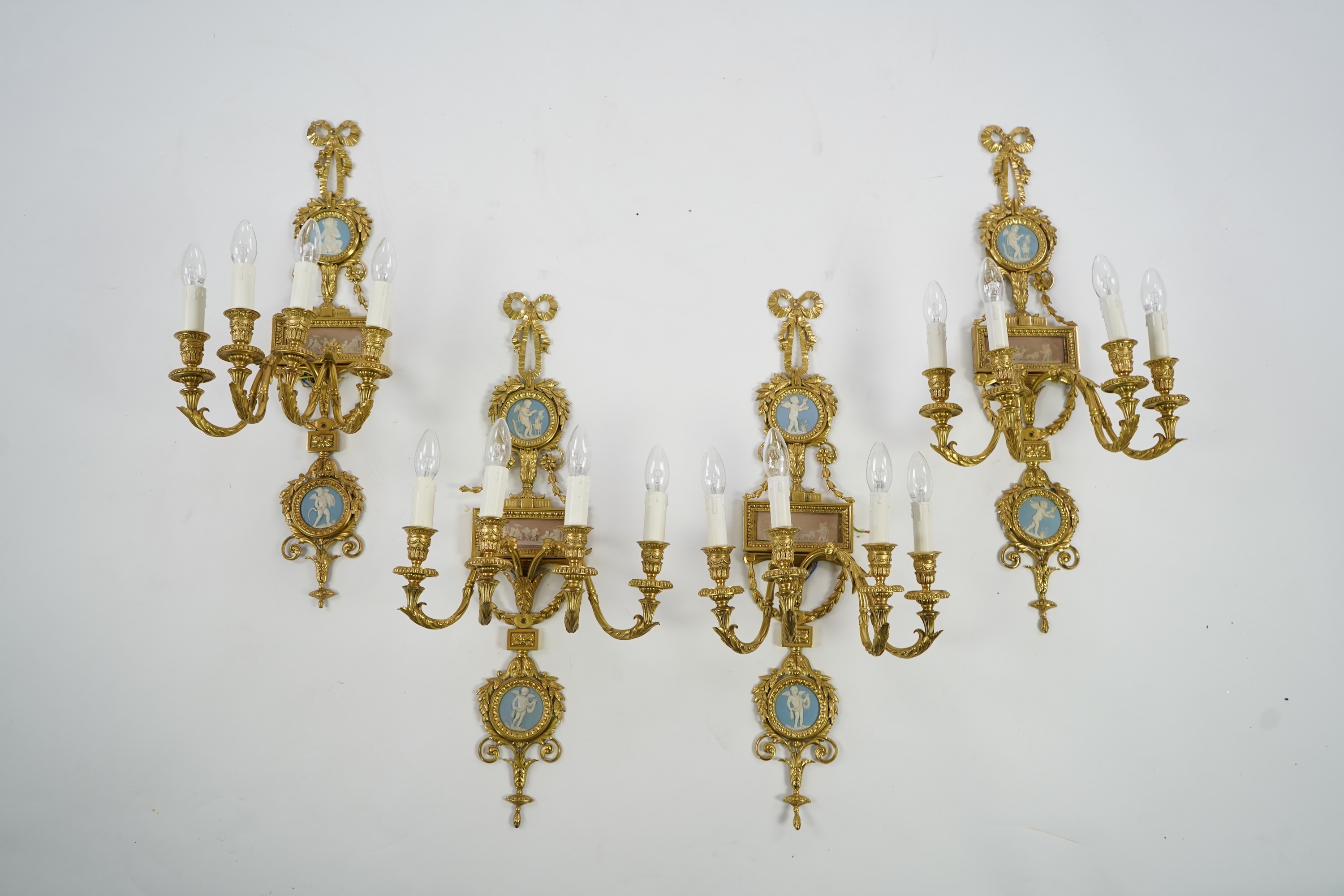 A set of four Adam style ormolu and jasper ware mounted wall appliques, early 20th century